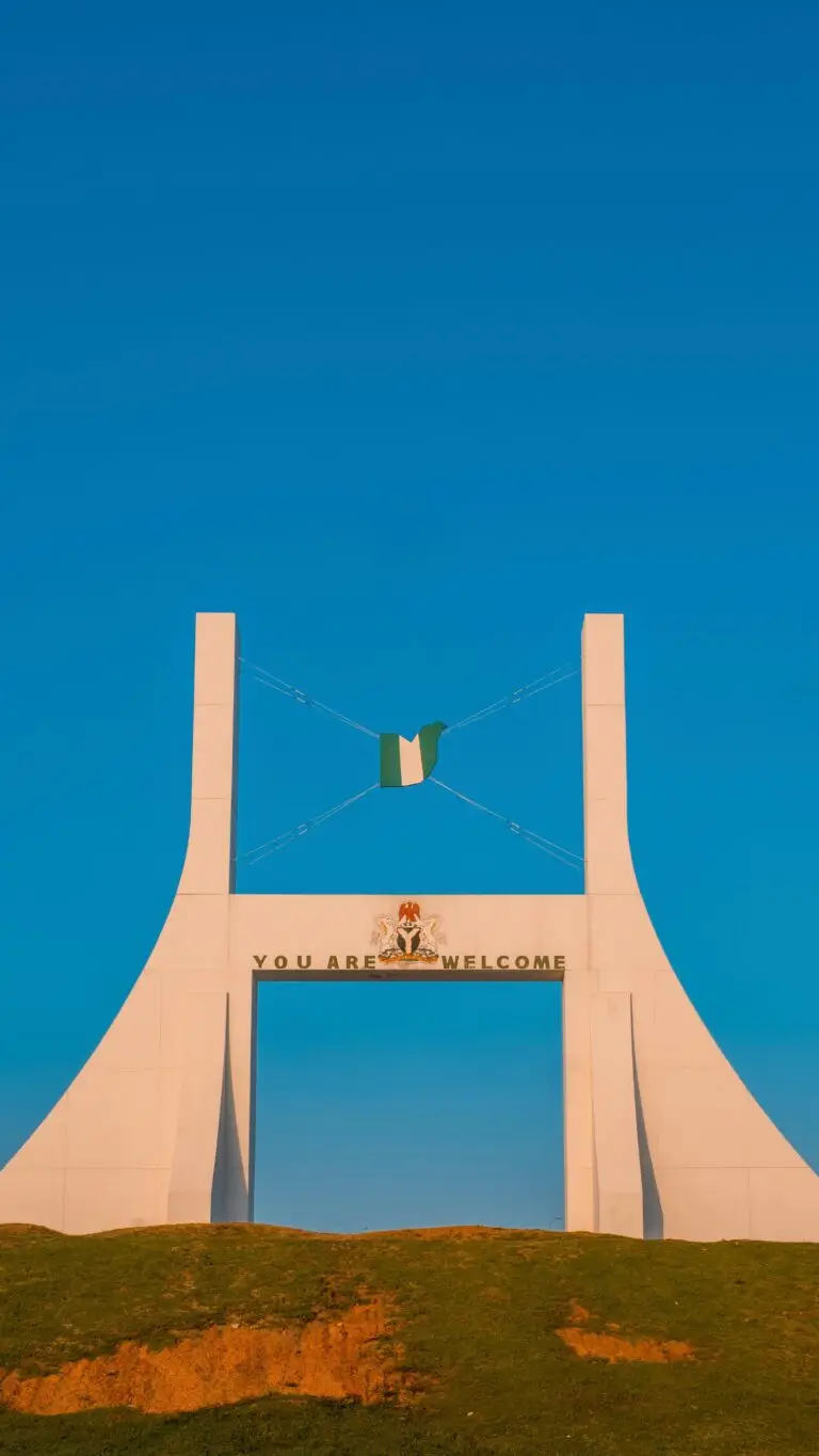 Captivating view of the Abuja City Gate with a clear blue sky, symbolizing Nigeria's capital.