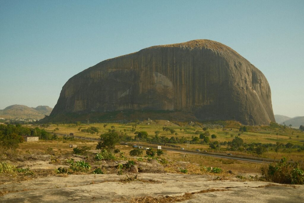 Iconic Zuma Rock with its stunning natural beauty in Abuja, Nigeria, stands majestically under the clear sky.