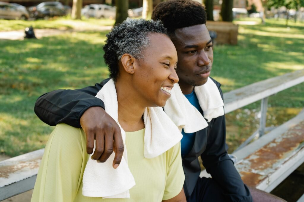 Mother and son bonding while sitting on a park bench outdoors.